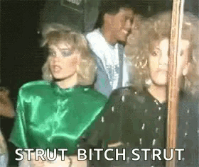 a group of women are standing next to each other in a dark room .