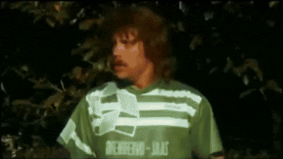 a man is wearing a green shirt that says ' nitro-jet ' on it .