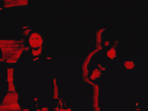 a blurry picture of a man in a black jacket with the word columbia on the back