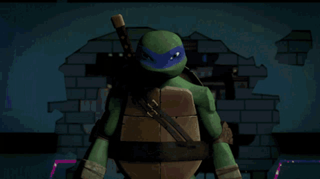 a teenage mutant ninja turtle is holding a sword in front of a brick wall