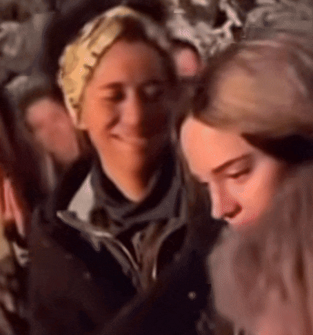 a blurry photo of a group of people including a woman wearing a headband