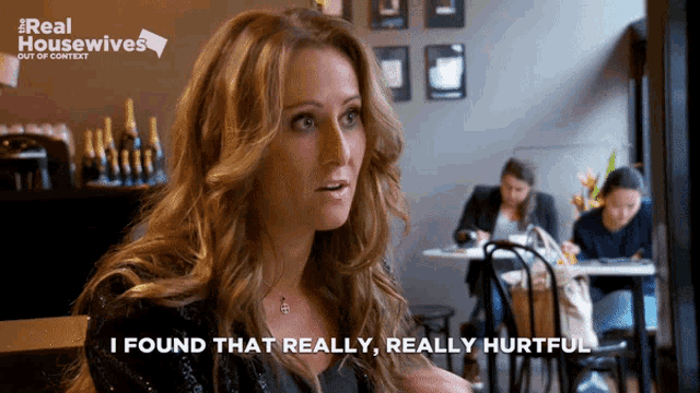 a woman is sitting at a table with the words i found that really really hurtful