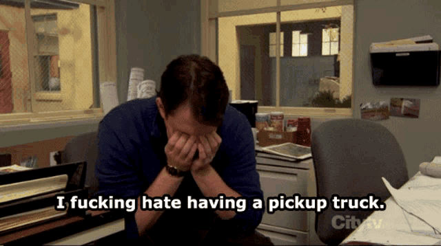 a man covering his face with his hands and the words i fucking hate having a pickup truck below him