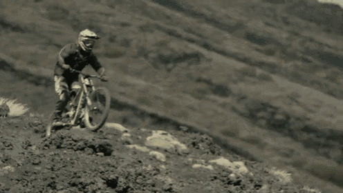 a person riding a bike down a hill