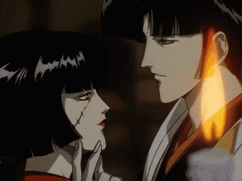 a man and a woman are looking at each other with a candle behind them