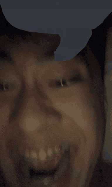a close up of a person 's face with a piercing in their nose