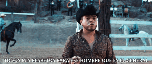 a man in a cowboy hat stands in front of a fence with the words todos mis respectos