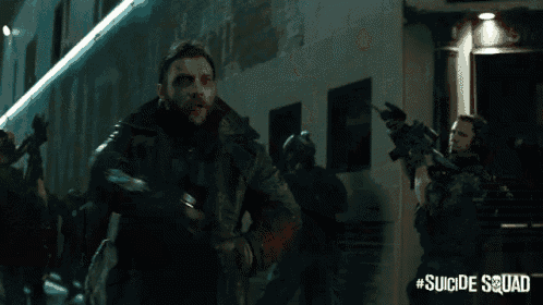 a man in a suicide squad costume stands in front of a building