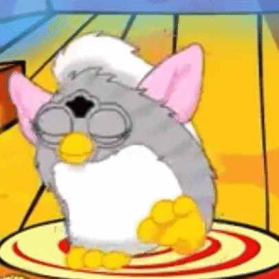 a cartoon furby is sitting on top of a plate .