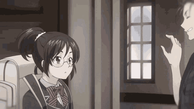 a girl with glasses and a ponytail is talking to a man