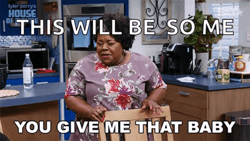 a woman is sitting in a chair in a kitchen with a caption that says this will be so me you give me that baby ..