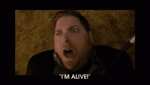 a man with his mouth open and the words " i 'm alive " above him