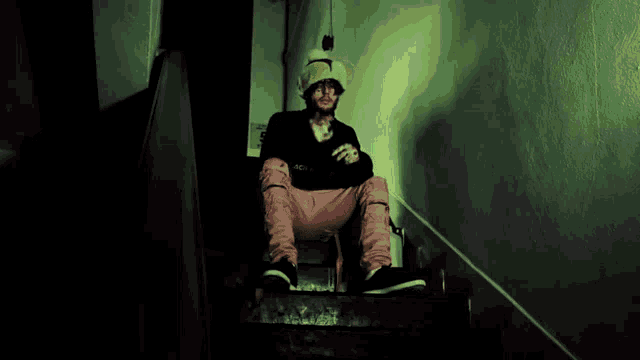 a person sitting on a set of stairs with a sign that says 5 on it