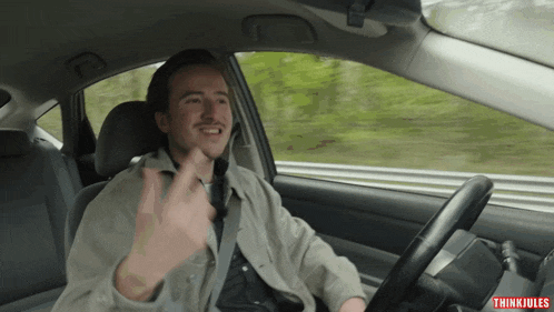 a man in a car with thinki jules on the bottom