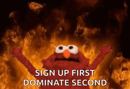 elmo from sesame street is standing in front of a fire .