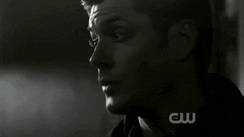 a close up of a man 's face in a dark room .