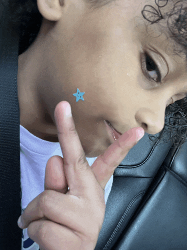a child with a blue star on his face