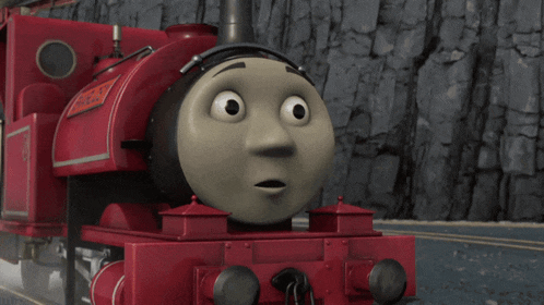 a red train with a sticker that says ' thomas ' on it