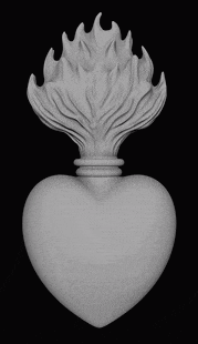 a statue of a heart with flames coming out of it .