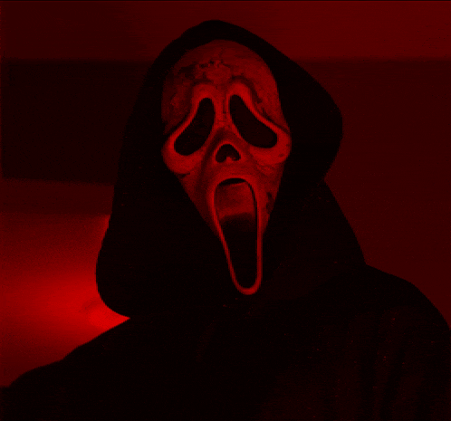 a scary screaming face with its mouth open in the dark