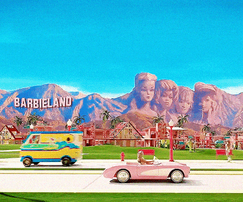 the word barbieland is on a sign above the street