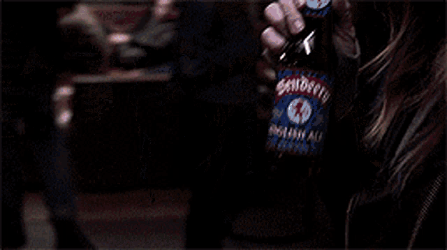 a woman is drinking a bottle of pepsi