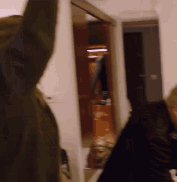 a blurry picture of a man standing in a hallway