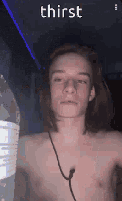 a young man without a shirt is holding a bottle of water and says thirst