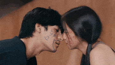 a man and a woman are kissing with hearts and stars drawn on their faces