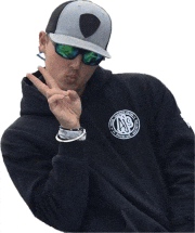 a man wearing sunglasses and a hat with a shield on it giving a peace sign