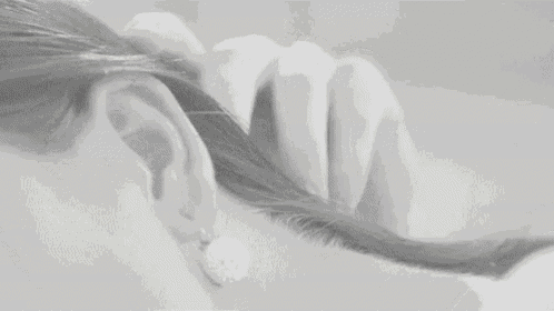 a woman 's ear with a pair of earrings on it