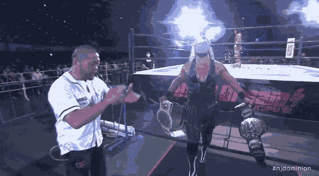 a man in a wrestling ring with the hashtag #njdominion