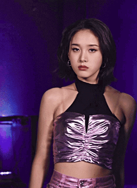 a woman wearing a purple top and a black top