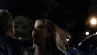 a woman is screaming in a dark parking lot while a recording is being taken