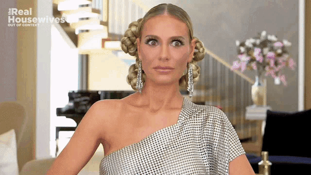 a woman in a silver one shoulder dress is featured on real housewives out of context