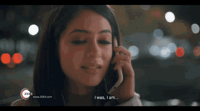 a woman is talking on a cell phone and says " i was , i am ... "