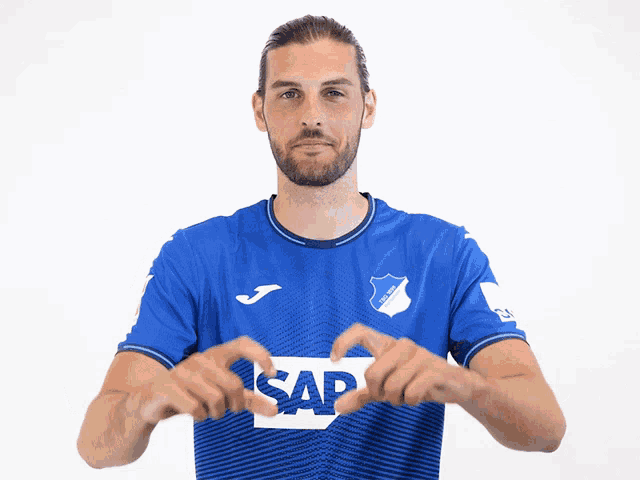 a man wearing a blue shirt with the word sap on the front