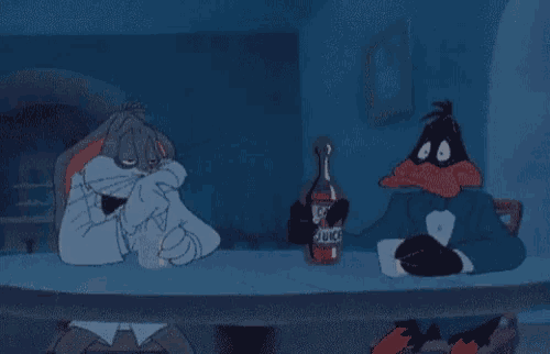 bugs bunny is sitting at a table with a bottle of juice