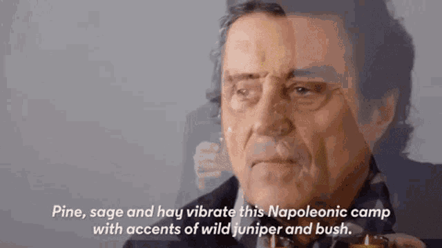 a close up of a man 's face with the words pine sage and hay