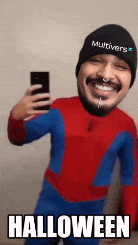 a man in a spiderman costume is taking a selfie with the words halloween written below him