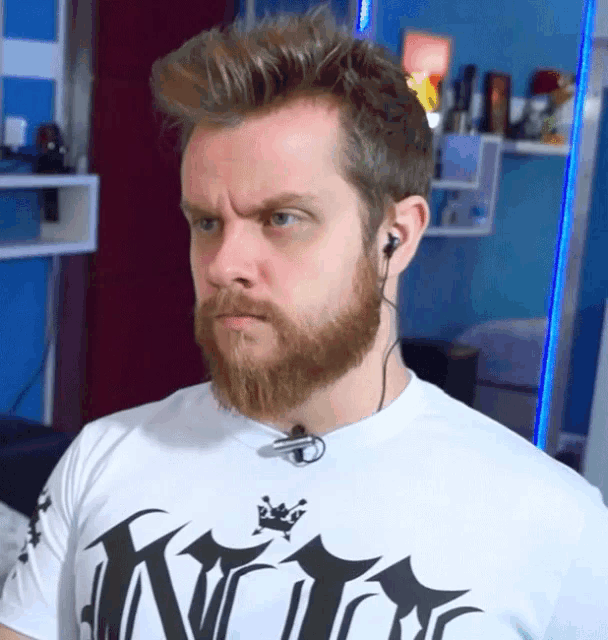 a man with a beard is wearing a king shirt