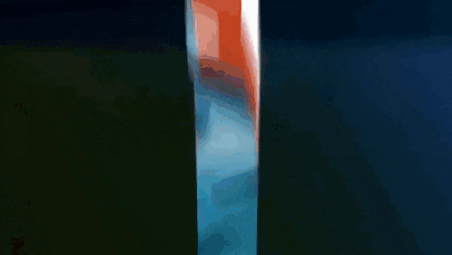 a close up of a person 's mouth with braces and a blue tie .