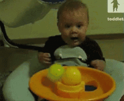 a baby is playing with a toy that says toddler on the bottom right