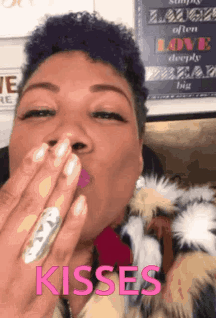 a woman with purple hair blowing a kiss with the words kisses behind her