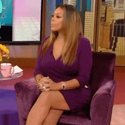 a woman in a purple dress is sitting in a purple chair
