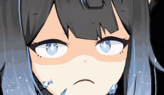a close up of a girl 's face with a sad look on her face