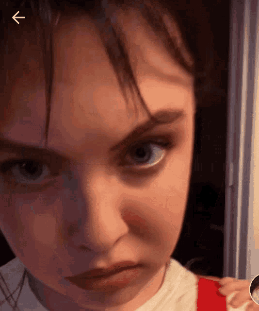 a close up of a person 's face with an arrow pointing to the right