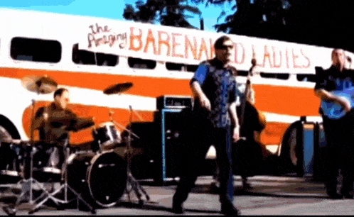 a band playing in front of a bus that says ' the amazing barenaked ladies '