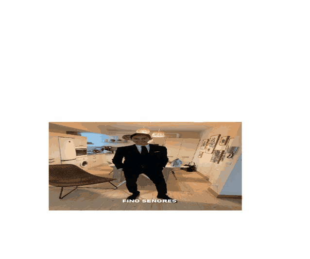 a man in a suit and hat is standing in a living room with the words find señores above him