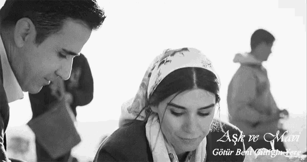 a black and white photo of a man and a woman with the words aşk ve mun written on the bottom